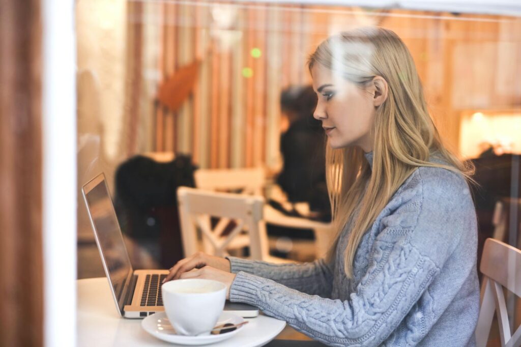 woman working on laptop in a coffee shop