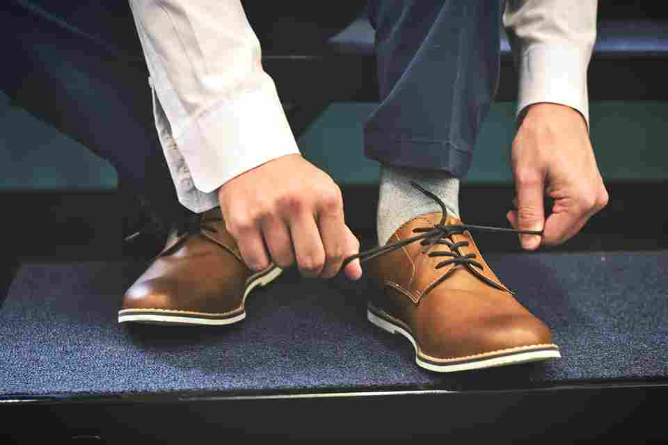 man tying his shoe lace