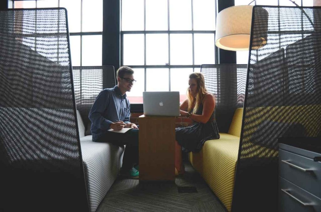 Two people working on laptop