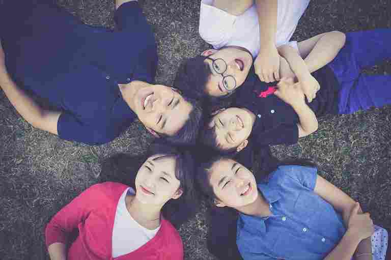 children lying in grass