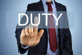 A man in a suit holding a duty button, symbolizing responsibility and authority.