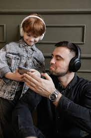 son and father listening to music