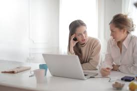 two women discussing at work