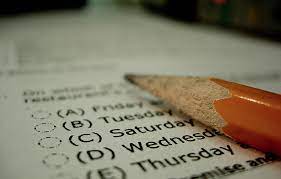 A pencil lying on a test paper, ready to be used for writing or drawing.