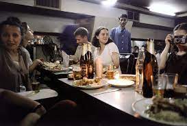 People gathered around a table with food.