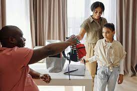 parents helping their daughter get ready for school