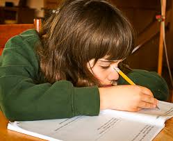 child drooping her head and studying