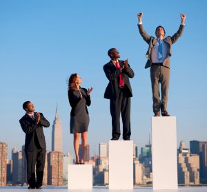 Business people celebrating success on pedestals.