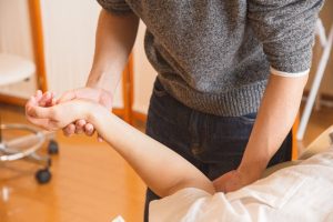 An image of a man tenderly grasping the arm of a woman.