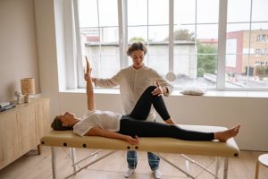 A woman giving a massage on a table, using her hands to apply pressure and promote relaxation.