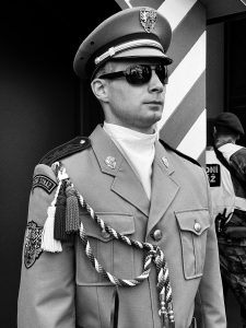  A man in a uniform standing tall with a serious expression.