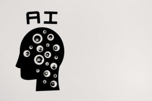 Monochrome image of a head with eyes and the word "ai" in bold font.