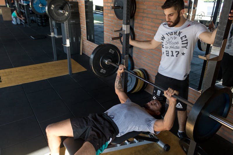 fitness coach training a woman at the gym